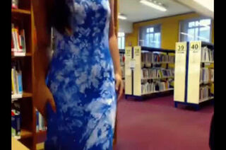 Lady undresses in library
